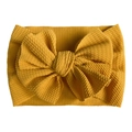 Detail of mustard yellow ribbed knit baby headband with a large soft decorative bow - Khaki/Earth Yellow