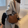 Brown half-moon shoulder bag in textured PU leather with a cute plush rabbit charm - Coffee With Rabbit Pendant