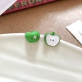 Detailed close-up of green apple stud earrings with rhinestone on a white ceramic plate - Green Apple Earrings