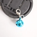 Detail of a bright blue metal bell pendant featuring a silver lobster clasp for keychains - Lake Blue