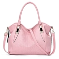 Pink faux leather handbag with crocodile pattern and top handle in a clean white background - Pink