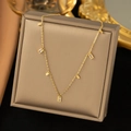 Golden stainless steel necklace with rectangular crystal pendants on a jewelry box - Crystal Square Necklace / Gold