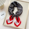 Elegant red and navy blue paisley print silk scarf in a stylish knot on a white display - Red Border Plaid