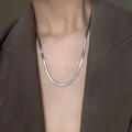 Polished silver snake chain necklace shown on a model in a professional business setting - 4mm Single Silver 50+5cm