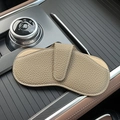 Minimalist beige pebble grain leather sunglasses pouch shown in a luxury car interior - Elephant Gray