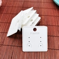 Macro detail of white jewelry display cards with Fashion print and hanging holes - 5*5cm