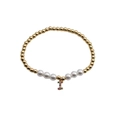 Detail view of pearl and gold bead bracelet featuring a colorful zircon letter I charm - Letter I