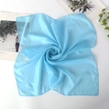 Light blue 100% silk square chiffon scarf shown in elegant swirl fold arrangement - Light Blue
