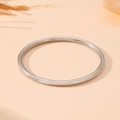 Detailed macro view of the silver stainless steel hinged clasp on this smooth metal bangle - Steel Smooth Oval Style (S503)
