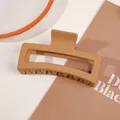 Macro detail of a large matte caramel hair claw clip with a sleek rectangular design - 13cm Rectangular - Matte Ginger Yellow
