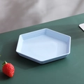 Modern light blue hexagonal fruit plate with gold rim and speckled finish on a green desk - Blue-Hexagon Dish