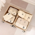 7-piece beige travel luggage organizer set with numbered mesh packing cubes inside a suitcase - Beige 7-Piece Set