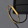 Sleek gold vacuum-plated stainless steel open bangle with custom engravable bar detail - Gold