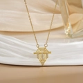 Macro view of gold geometric shield pendant with micro-pave cubic zirconia on beige fabric - Gold Geometric Trapezoid Zirconia Style (XL0473)