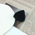Detail of a small black flocked triangular hair clip on a white plate with newspaper - 4# Cat Ear Black