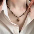 Detail of vintage beaded necklace with brown tiger eye stone and golden oval pendant - Oval Pendant Vintage Ethnic Chain (58#) / Gold-Coffee-Black
