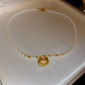 Macro detail of Chinese Fu lucky bag pendant with white pearls on a textured jewelry box - Pearl Fu Character Lock Style(28#)