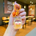 Detailed close-up of a glowing bubble Lilith keychain with yellow glitter bear hood and bell - Lobster Clasp Style / Noctilucent Bubble Bead Orange