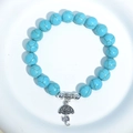 Blue turquoise beaded bracelet featuring a silver metal umbrella charm pendant - Blue Turquoise Umbrella Charm