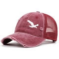 Close-up view of vintage distressed maroon mesh trucker cap with white bird embroidery - Adjustable / Burgundy
