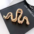 Pinza para el pelo minimalista de metal con forma de serpiente en acabado dorado pulido - 10.5cm / Dorado