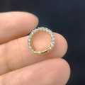 Macro shot of gold-plated hinged nose ring with micro-pave white cubic zirconia stones - Row Zircon Hoop