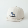 Close-up of soft beige baby cap featuring blue elephant embroidery and brand label detail - Elephant / Beige
