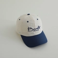 Close-up of kids' quick-dry baseball cap with Burnette NESOE navy embroidery and brim - Navy Blue