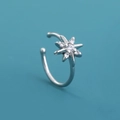 Mini silver star nose ring with inlaid crystals on a solid blue background - Star Flower (SE1256)