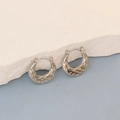Detailed macro view of vintage silver oval hoop earrings with petal texture pattern - Silver Vintage Floral Crescent