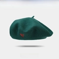 Dark green wool beret featuring a delicate red embroidered heart on a clean white background - Green