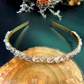 Detailed view of handmade crystal crown headband with gold wire on a rustic wooden base - White Crystal with Gold Wire Gold Headband