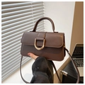 Detail of dark brown leather handbag featuring a stylish gold D-buckle and top handle - Brown
