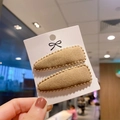 Close-up of khaki faux cashmere teardrop BB hair clips for girls on a display card - Khaki
