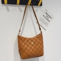 Quilted brown bucket shoulder bag with elegant gold flower hardware in caramel finish - Brown