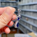 Detailed view of teardrop royal blue zircon earrings with pear-cut silver metal setting - Clip-On Earrings / Blue