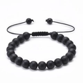 Detailed macro of handmade black matte lava stone bracelet with adjustable braided cord - Matte Stone