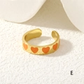 Detailed close-up of golden wide-band open ring featuring four orange enamel hearts - Orange Hearts (RG0446-E)