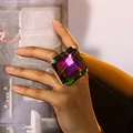 Macro view of a large square-cut multicolor crystal ring on a silver prong setting - Colorful