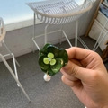 Close-up of green resin flower earring with shimmering center stone and pearl drop charm - Flower Duckbill Clip / Dark Green Flower