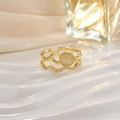 Detail of gold stacking rings featuring a round beige opal and sparkling wave band - Yellow Round Gem Wave Band Set (JZ0149)
