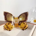 Brown and yellow butterfly hair claw clip with realistic wing patterns on a wooden tray - Old World Swallowtail 11CM