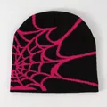 Detailed knit texture of a black streetwear beanie featuring a hot pink spider web pattern - Black with Magenta Web