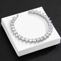 Macro shot of silver heart-shaped tennis chain with zircons on a white jewelry box - 10 inch (25cm) / Silver Anklet (White Zircon)