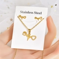 Detail of gold stainless steel heartbeat and paw print jewelry set on display card - ECG Paw Print Style (TT-075)