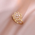 Macro shot of gold clover ring with pink and clear crystals on pink silk fabric - Gold Pink Rotating Ring (J0154)