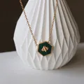 Macro shot of honeycomb bee pendant with green malachite on a gold titanium steel chain - Gold Green Bee / Green
