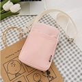 Pink fabric mini crossbody bag with white adjustable strap and stylish black woven label - Pink