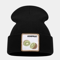 Detail of embroidered kiwi fruit patch on a black knitted beanie with clear texture - Kiwifruit Pattern