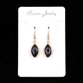 Elegant gold earrings with faceted black marquise gemstones on a white card display - Obsidian